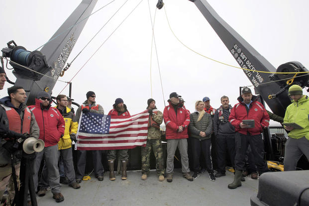 The project team and members of the crew of the R/V Norseman II conduct a wreath ceremony to honor the final resting place of the 71 Sailors lost on the USS Abner Read. (Image courtesy of Kiska: Alaska's Underwater Battlefield expedition)