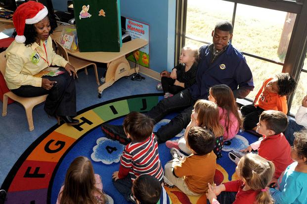 Ms. Martha Razor, an early childhood specialist with WHRO public media, reads to preschoolers at the Willoughby Child Development Center at Naval Station Norfolk, Virginia, on Dec. 12, 2012. (U.S. Navy photo by Mass Communication Specialist 3rd Class Molly Greendeer)