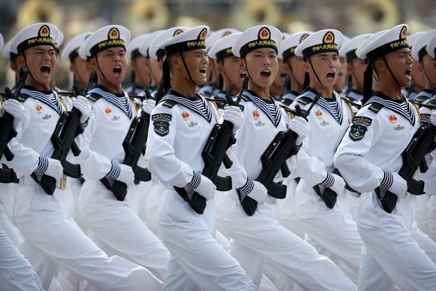 Soldiers from China's People's Liberation Army (PLA) Navy march in formation.