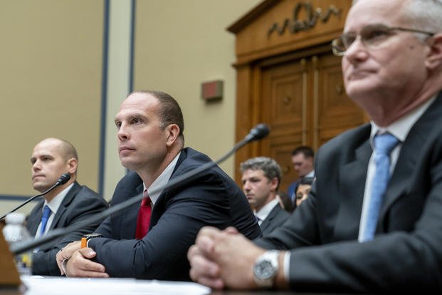 Three men testify before Congress. 