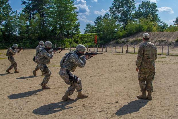 2017 Army Reserve Best Warrior winners and runners up practice movement with a M4 rifle on a transition fire range. 