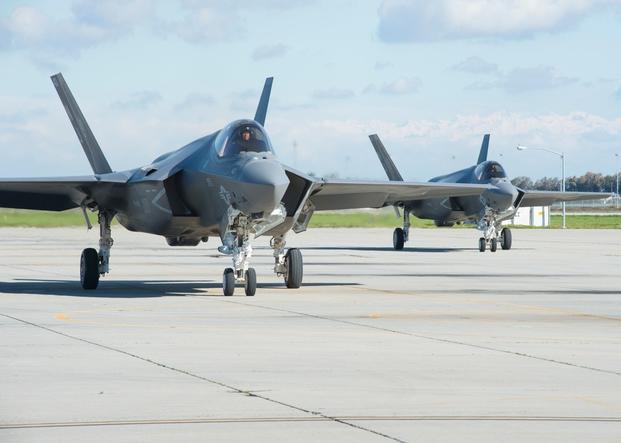  F-35C Lightning II joint strike fighter aircraft taxi across the flight line at Naval Air Station Lemoore.