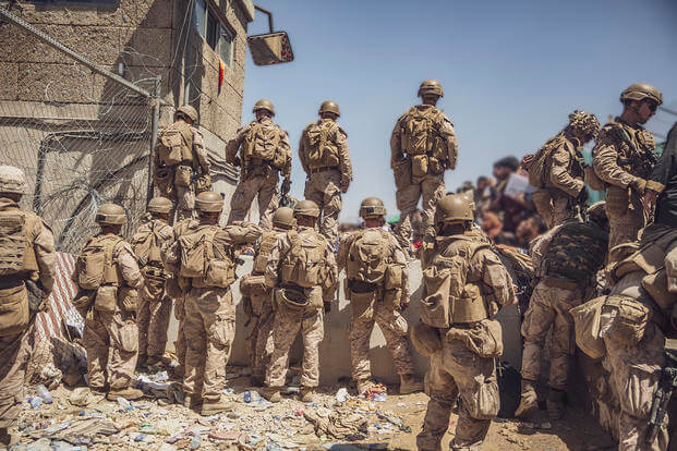 U.S. Marines with Special Purpose Marine Air-Ground Task Force - Crisis Response - Central Command assist with security at an Evacuation Control Checkpoint (ECC) during an evacuation at Hamid Karzai International Airport, Kabul, Afghanistan.