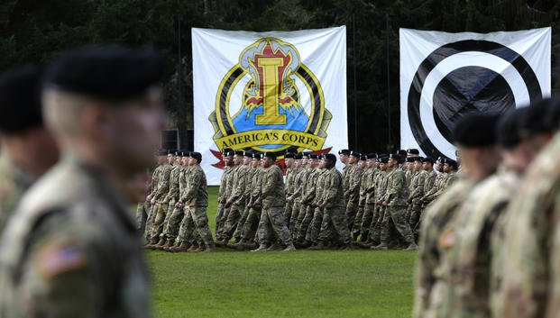 Army troops march in formation during a change of command ceremony