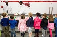 Damian Lofton, work leader, shows children from Cody Child Development Center's Robins B class of 4-to 5-year-olds packaged ground beef during a tour of Joint Base Myer-Henderson Hall's commissary. (U.S. Army/Rachel Larue)