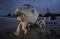 U.S. Airmen with the 332nd Expeditionary Security Forces Squadron provide aircraft security for a C-130 Hercules aircraft from the 463rd Airlift Group at Balad AirBase, Iraq (photo: U.S. Air Force Master Sgt. Lance Cheung)