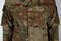 The Air Force is adopting the Army's Operational Camouflage Pattern for its new combat uniform and began incrementally phasing it in Oct. 1. The Air Force will differentiate itself by using a &quot;spice brown color&quot; for velcro patches, name tape and insignia. Air Force photo