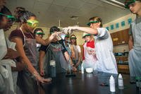 Anna Sansone, a seventh grade science teacher at Vicenza Middle School, guides students during an experiment in her classroom. Department of Defense Education Activity named Sansome Teacher of the Year for 2019. (Robert Wormley/Armed Forces News)