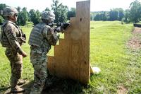 A sergeant from the 4th Infantry Division standing near a cadet as he negotiates the new buddy-team live fire course at ROTC Advanced Camp at Fort Knox, Kentucky. (U.S. Army/Spc. Dana Clarke)