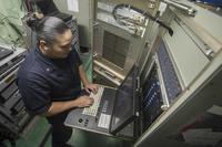 A U.S. Navy information systems technician troubleshoots a server.