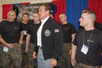 U.S. Marines stand with Arnold Schwarzenegger as he jokes with the crowd at the 2013 Arnold Sports Festival in Columbus, Ohio.