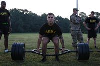 An explosive ordnance disposal team member does the deadlift portion of the Army combat fitness test.