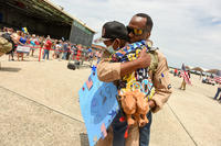A member of the Air National Guard hugs his son at homecoming.