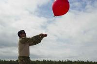 An airman releases a weather balloon at Eglin Air Force Base.