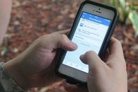 A service member modifies their social media preferences to reduce the risk of identity theft.