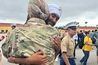 Pfc. Jaskirat Singh hugs Lt. Col. Kamaljeet Singh Kalsi