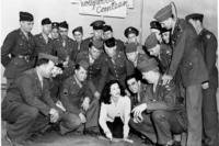 Hedy Lamarr autographs the cement court at the United Service Organizations (USO) Hollywood Canteen as servicemen surround the movie actress on Dec. 13, 1942.