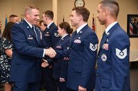 Col. Chad Ellsworth, installation commander, congratulates Tech. Sgt. Amos Hard, 66th Air Base Group Command Post controller, on his promotion during the September Enlisted Promotion Ceremony at Hanscom Air Force Base, Mass.