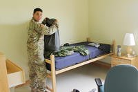 An Army private begins unpacking his belongings in his barracks room on US Army Garrison Humphreys, South Korea.
