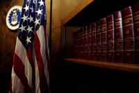 Volumes of “Court-Martial Reports” line the bookshelf in a courtroom